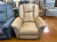 A La-Z-Boy Jasper Recliner 709-10-D1855-75 in tan upholstery, featuring a plush pillow back cushion, is showcased in a furniture store alongside other wide seat recliners in assorted colors and fabrics on a polished brown floor.
