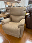 A La-Z-Boy Trouper Recliner 724-10-D1855-75 in tan, featuring plush cushions, is showcased in a furniture store alongside various chairs, sofas, tables, and lamps on a glossy brown floor.