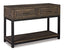 The Ashley Johurst Sofa Table T444-4 features a wooden construction with two drawers, a lower shelf, and black metal legs; this modern farmhouse piece is displayed at an angle on a white background.