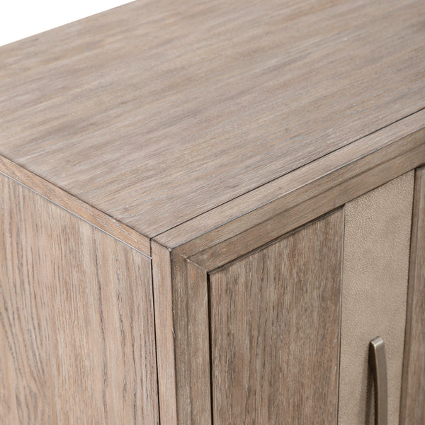 Close-up of the top corner of the Liberty Furniture Lafayette Curio Cabinet 2219-AC1000, featuring a light natural finish and a metallic vertical handle on the door, providing a stylish storage solution.