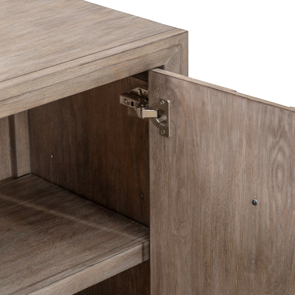 A close-up of an open Lafayette Curio Cabinet 2219-AC1000 by Liberty Furniture reveals a metal hinge affixed to the interior edge, with shelves visible inside this elegant accent cabinet and versatile storage solution.