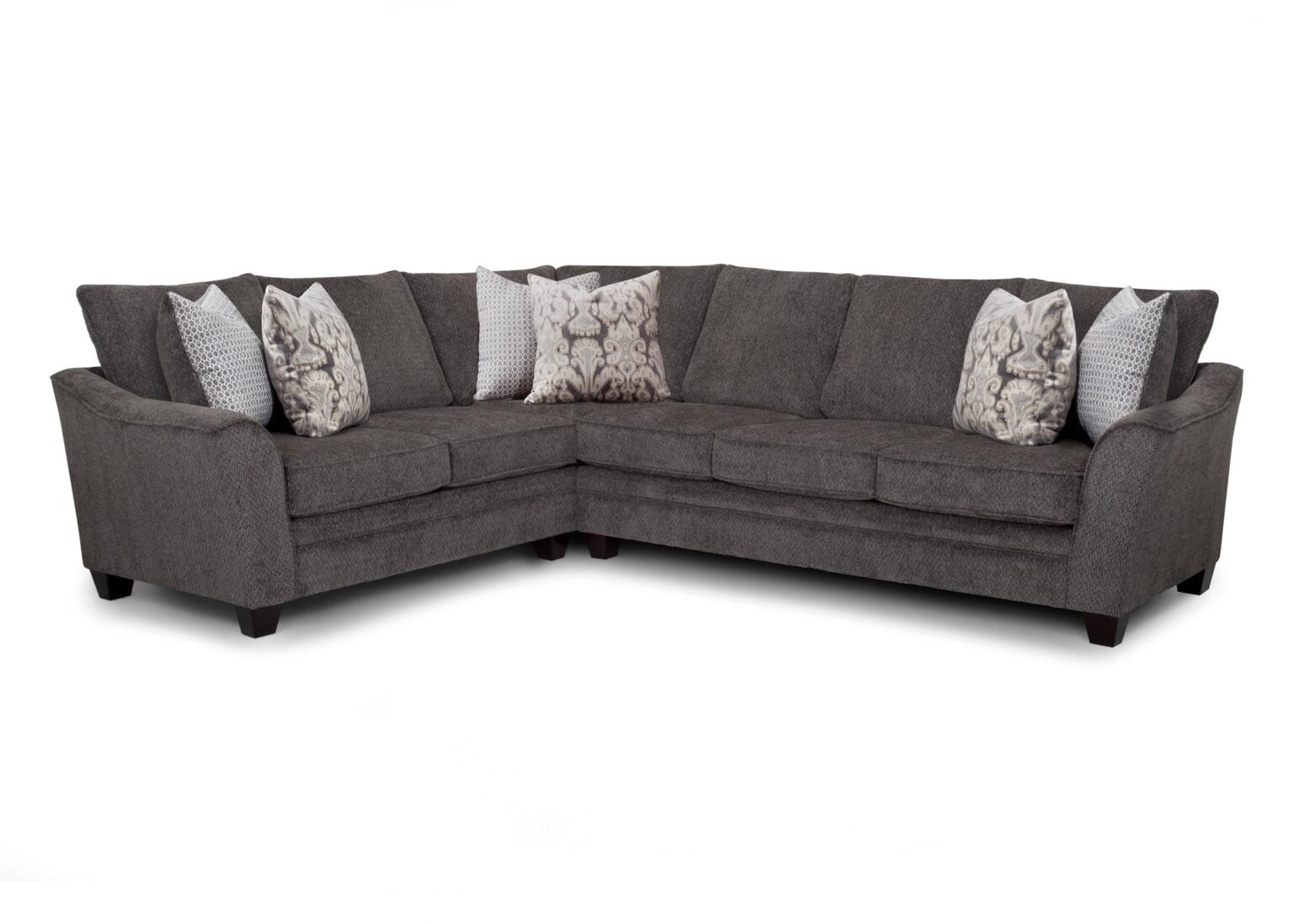 The Fairmont Shasta Charcoal Sectional (256-28-49-3403-05) by Franklin Furniture Corp. is an L-shaped sofa in gray, designed with dark wood legs and complemented by five patterned throw pillows in various shades of gray and white. Set against a plain white background, this stylish modern sectional adds a sophisticated touch to any living space.