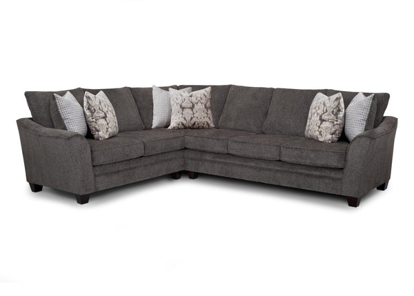 The Fairmont Shasta Charcoal Sectional (256-28-49-3403-05) by Franklin Furniture Corp. is an L-shaped sofa in gray, designed with dark wood legs and complemented by five patterned throw pillows in various shades of gray and white. Set against a plain white background, this stylish modern sectional adds a sophisticated touch to any living space.
