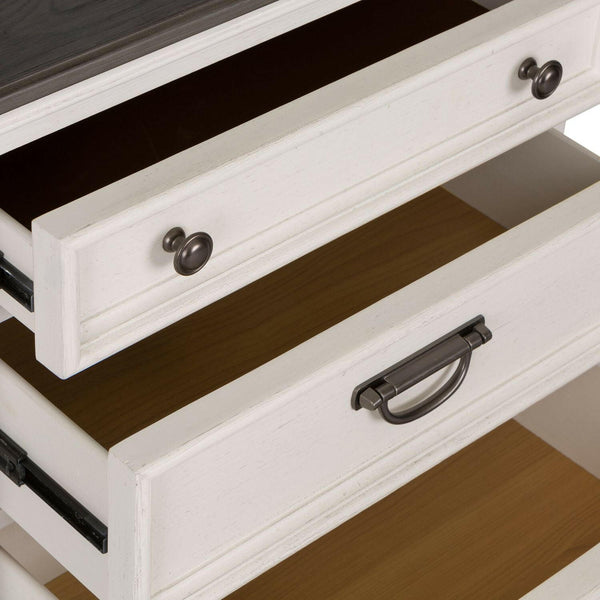 A close-up of a white wooden dresser with two open drawers, featuring different metal handles: a round knob handle on the top drawer and a curved pull handle on the bottom drawer.