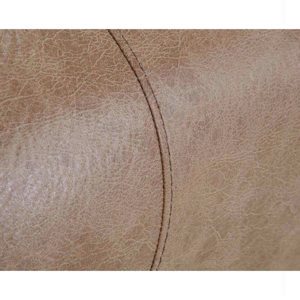 Close-up of a textured light brown leather surface with visible stitching and natural creases, highlighting the premium craftsmanship of the Trilogy Marshall Camel Recliner 4595-8621-25 by Franklin Furniture Corp. This manual recliner features a WOW Seating System for enhanced comfort.