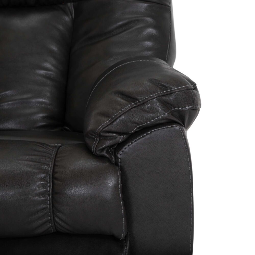 Close-up of the Connery Blaze Slate Recliner 4703-LM99-03 by Franklin Furniture Corp., highlighting the padded armrest and detailed stitching. The dark brown leather upholstery features a soft, textured surface with gentle creasing, suggesting a comfortable, plush seating experience enhanced by a gel-blended foam cushion.