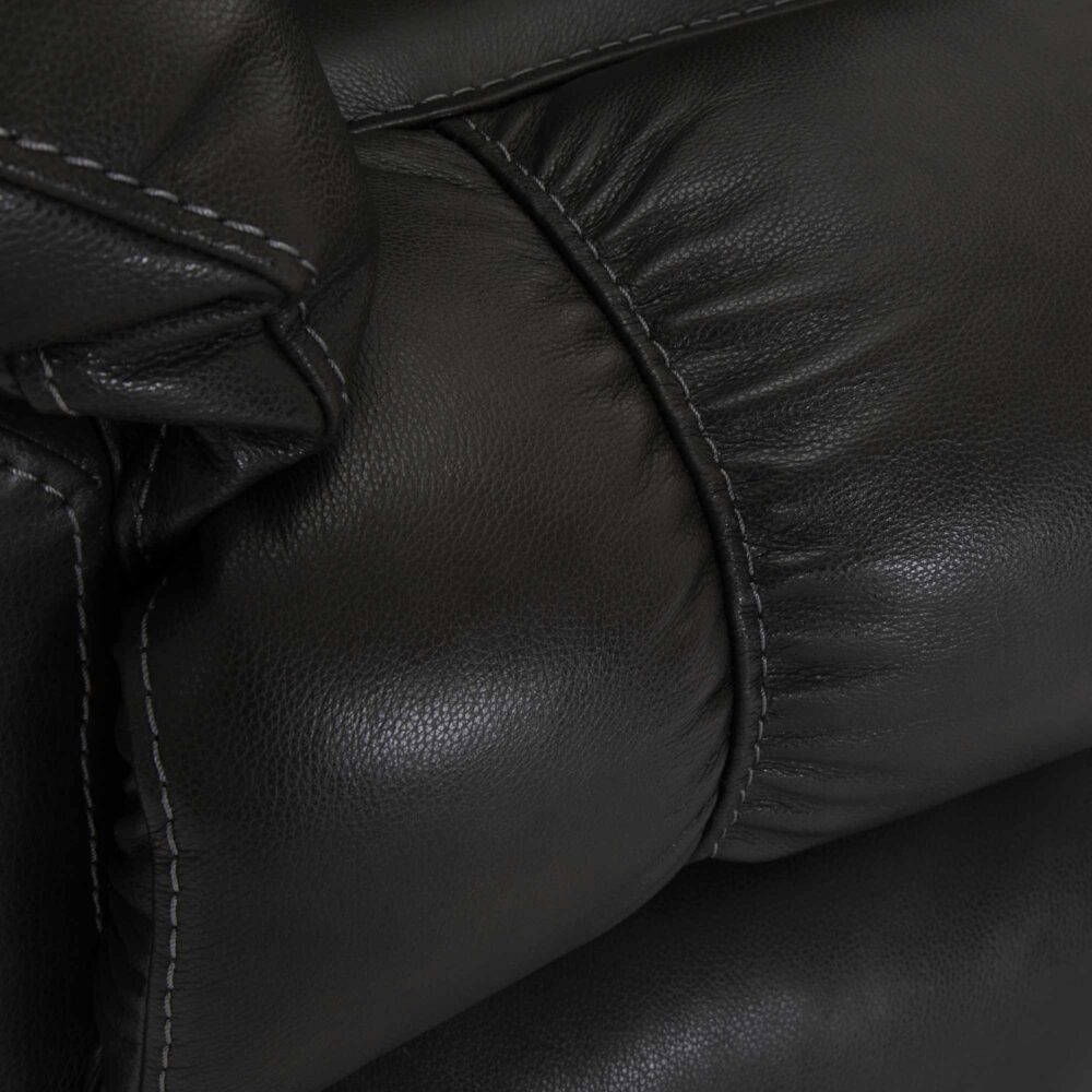 Close-up of the Connery Blaze Slate Recliner (model 4703-LM99-03) by Franklin Furniture Corp., highlighting the black leather upholstery with visible seams and stitching, showcasing the texture and folds of the material.