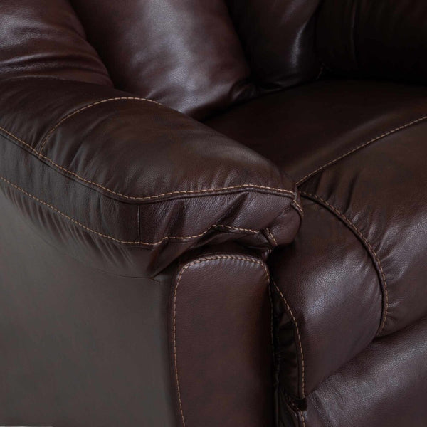 Close-up of the armrest and cushion of the Connery Blaze Bourbon Recliner by Franklin Furniture Corp. (model 4703-LM99-14) in dark brown leather, featuring visible stitching and a soft, gel-blended foam cushion for added comfort.