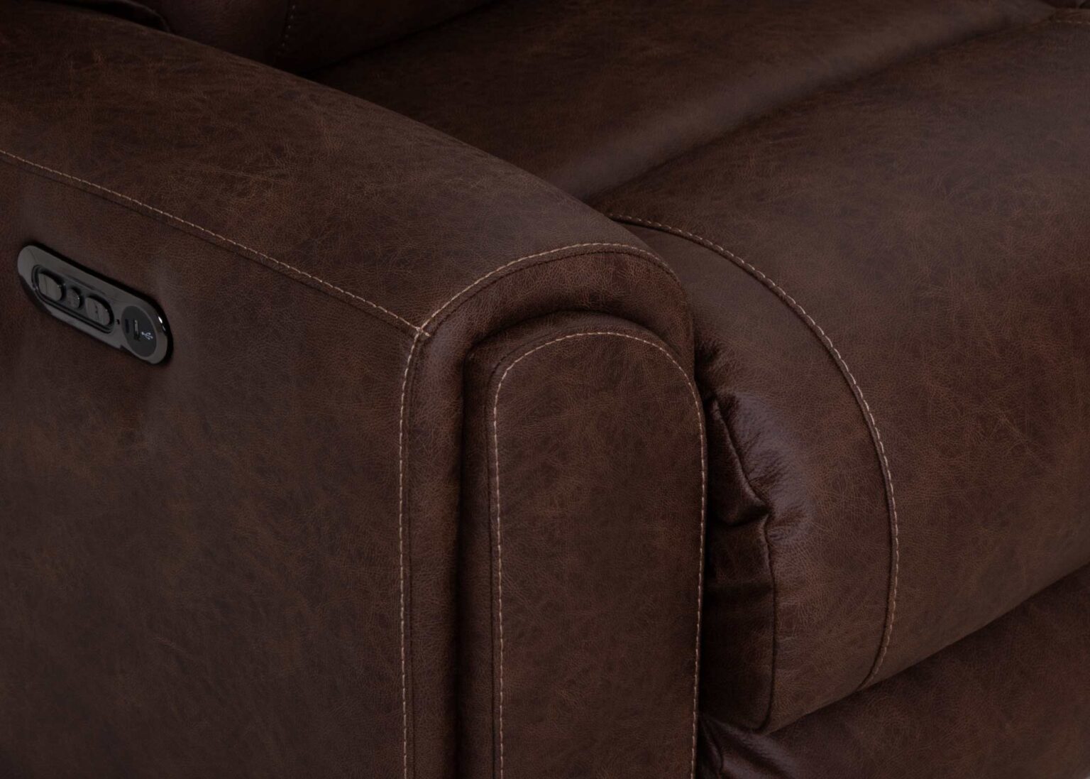Close-up of a brown leather armrest on the Phoenix Seattle Auburn Sectional 693-31-56-99-7511-18 by Franklin Furniture Corp., highlighting detailed stitching and an integrated control panel, showcasing the comfort and technology of the WOW Seating System commonly found in premium power recline sofas.