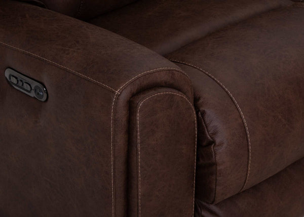 Close-up of a brown leather armrest on the Phoenix Seattle Auburn Sectional 693-31-56-99-7511-18 by Franklin Furniture Corp., highlighting detailed stitching and an integrated control panel, showcasing the comfort and technology of the WOW Seating System commonly found in premium power recline sofas.