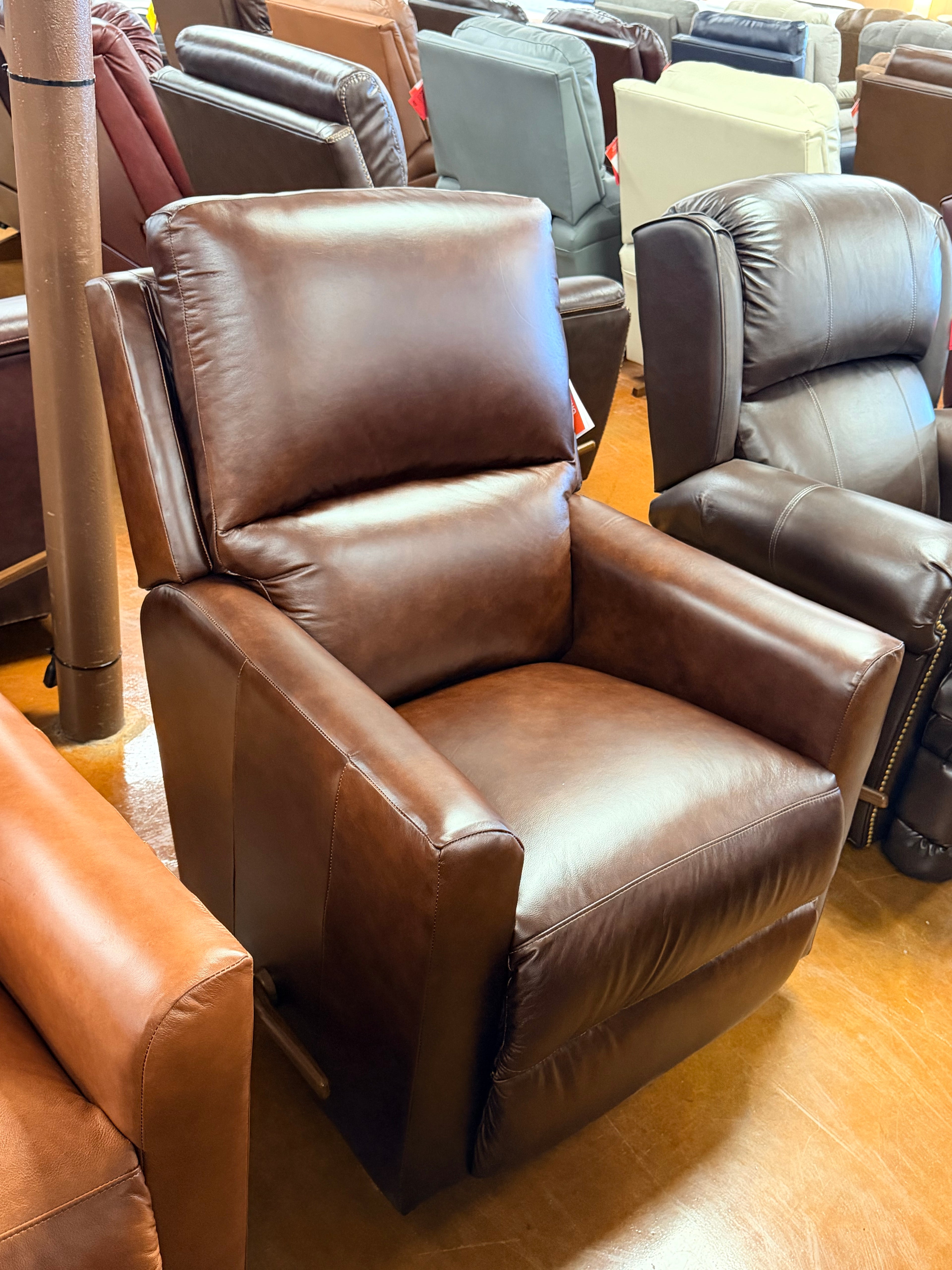 Brown leather recliner chair in a showroom setting