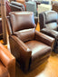 Brown leather recliner chair in a showroom setting