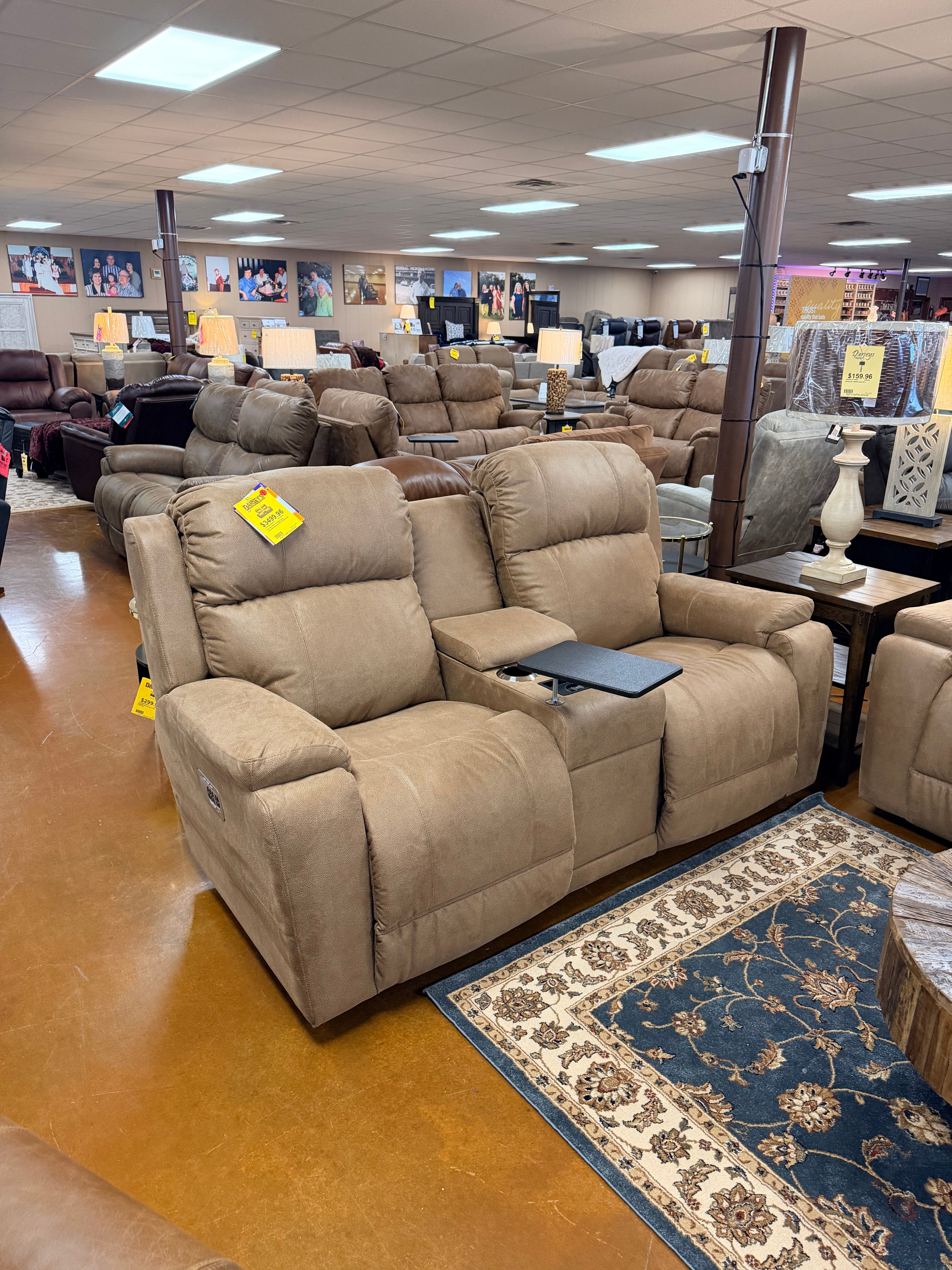 Two Dorian Power Loveseat Reclining chairs (755-X49-D1855-75), brown with center console and tray table, are showcased in a furniture store among couches and recliners under bright ceiling lights on a brown floor. Main image