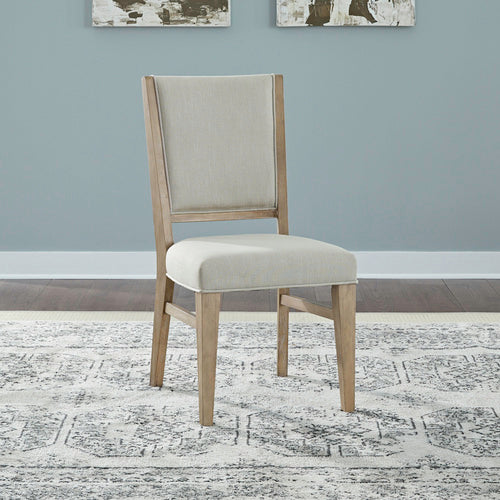 A light wood Brentwood Table and 6 Chairs 789-C6501S-P4402-T4402 side chair featuring an upholstered beige seat and backrest.