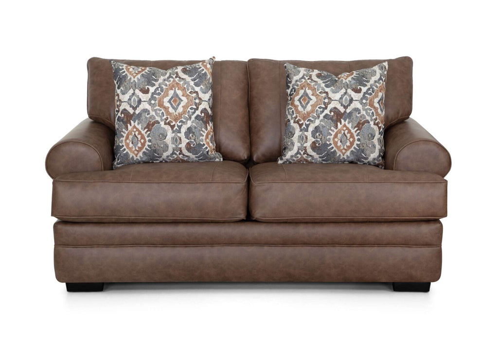 The Langston Duvall Vintage Brown Loveseat 83220-3429-16 by Franklin Furniture Corp. features wide padded arms, two seat cushions, and two patterned throw pillows in shades of gray, brown, and orange. Set against a white background, this inviting loveseat from the Langston Collection is designed with the WOW Seating System for superior comfort.