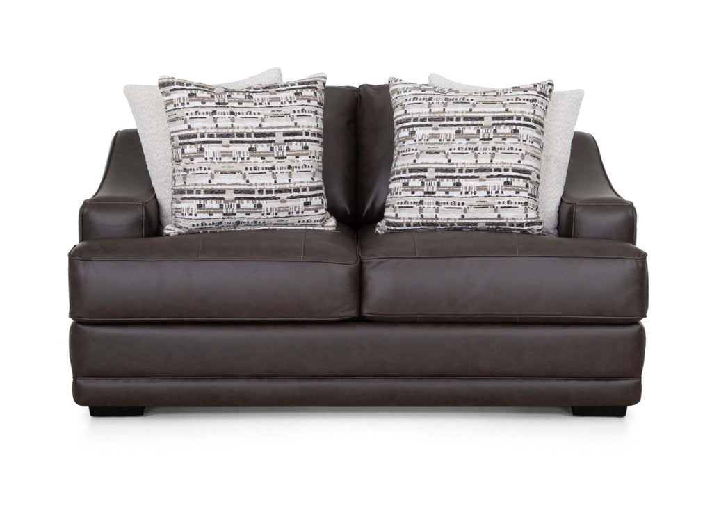The Prescott Duvall Coffee Loveseat 89340-3429-10 by Franklin Furniture Corp. showcases a rich dark brown premium chocolate fabric, enhanced by the WOW Seating System, and is complemented with two patterned black and white throw pillows along with two solid light-colored pillows, all displayed on a white background.