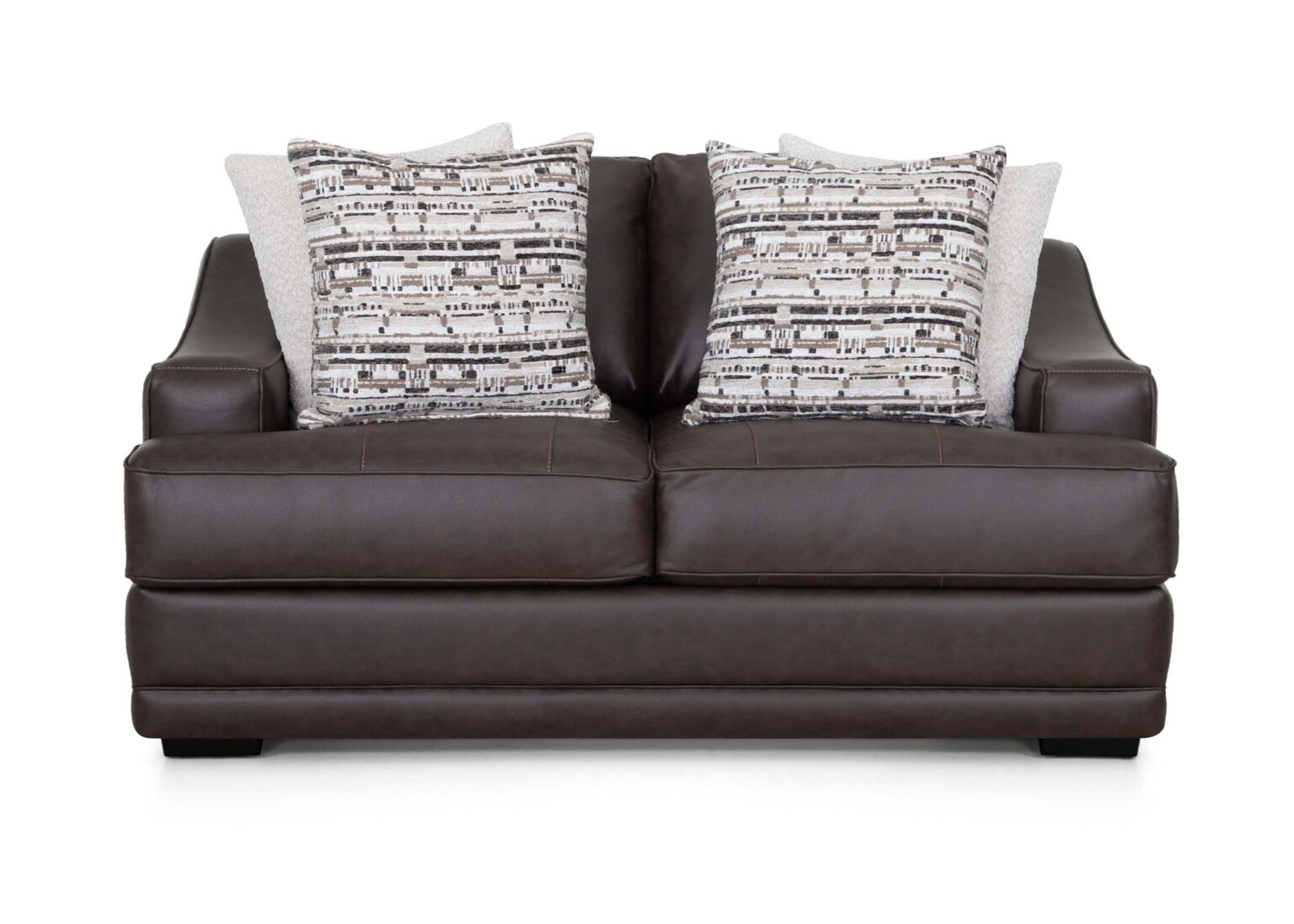 The Prescott Duvall Coffee Loveseat 89340-3429-10 by Franklin Furniture Corp. showcases a rich dark brown premium chocolate fabric, enhanced by the WOW Seating System, and is complemented with two patterned black and white throw pillows along with two solid light-colored pillows, all displayed on a white background.