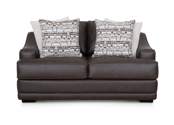 The Prescott Duvall Coffee Loveseat 89340-3429-10 by Franklin Furniture Corp. showcases a rich dark brown premium chocolate fabric, enhanced by the WOW Seating System, and is complemented with two patterned black and white throw pillows along with two solid light-colored pillows, all displayed on a white background.