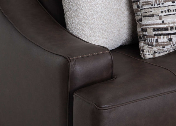 Close-up of the Prescott Duvall Coffee Loveseat by Franklin Furniture Corp., upholstered in rich dark brown leather reminiscent of premium chocolate, with beige textured and patterned decorative pillows arranged along the backrest.