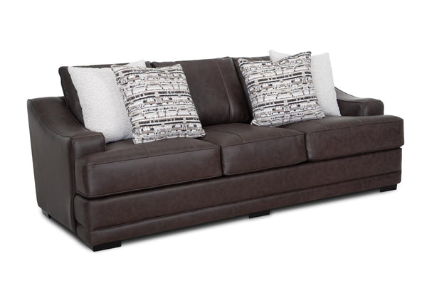 The Prescott Duvall Coffee Sofa (89340-3429-10) by Franklin Furniture Corp. showcases a dark brown leather exterior with three plush seat cushions and four decorative pillows—two in a textured white fabric and two featuring a black, gray, and white geometric design. Resting on compact black feet and set against a white background, this sofa delivers the inviting comfort of rich chocolate fabric along with outstanding support provided by its advanced WOW Seating System.