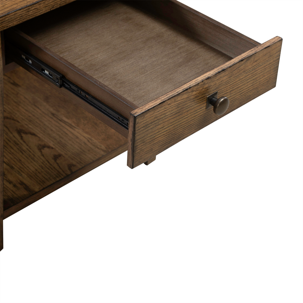 A close-up of the Carolina Park End Table 930-OT1020 by Liberty Furniture, featuring an open storage drawer with a round metal knob that reveals the interior and part of the sliding mechanism. The piece showcases a rich dark wood finish.