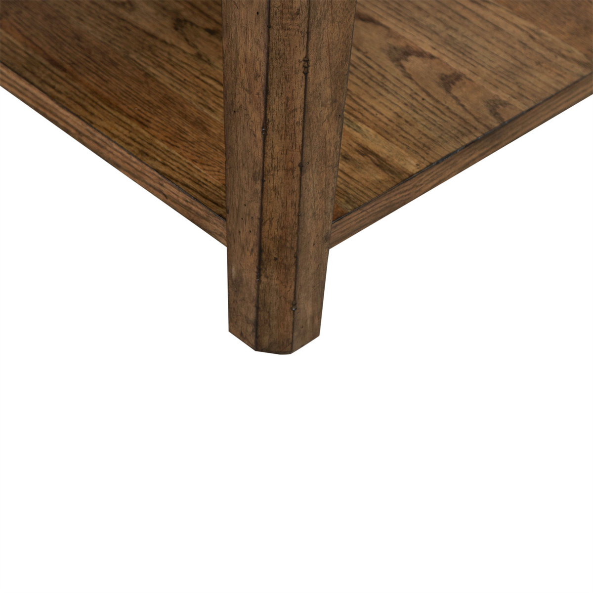 Close-up of the corner of the Carolina Park End Table 930-OT1020 by Liberty Furniture, highlighting the stunning white oak wood grain and meticulous construction details. The image features a lower shelf against a crisp white background, beautifully capturing the timeless elegance of this end table.
