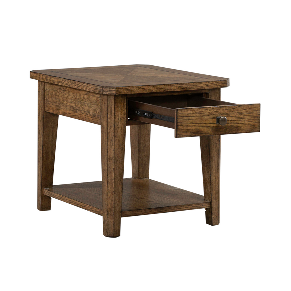 The Liberty Furniture Carolina Park End Table 930-OT1020 features a brown wooden finish, square top, lower shelf for additional storage, and one open drawer with a round metal knob. Supported by four legs, this end table has a simple rustic design that complements any space.