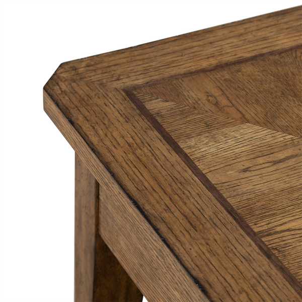 Close-up of the corner of the Liberty Furniture Carolina Park End Table 930-OT1020, showcasing its detailed wood grain pattern and beveled edge. This white oak end table features a warm brown finish and sturdy construction.