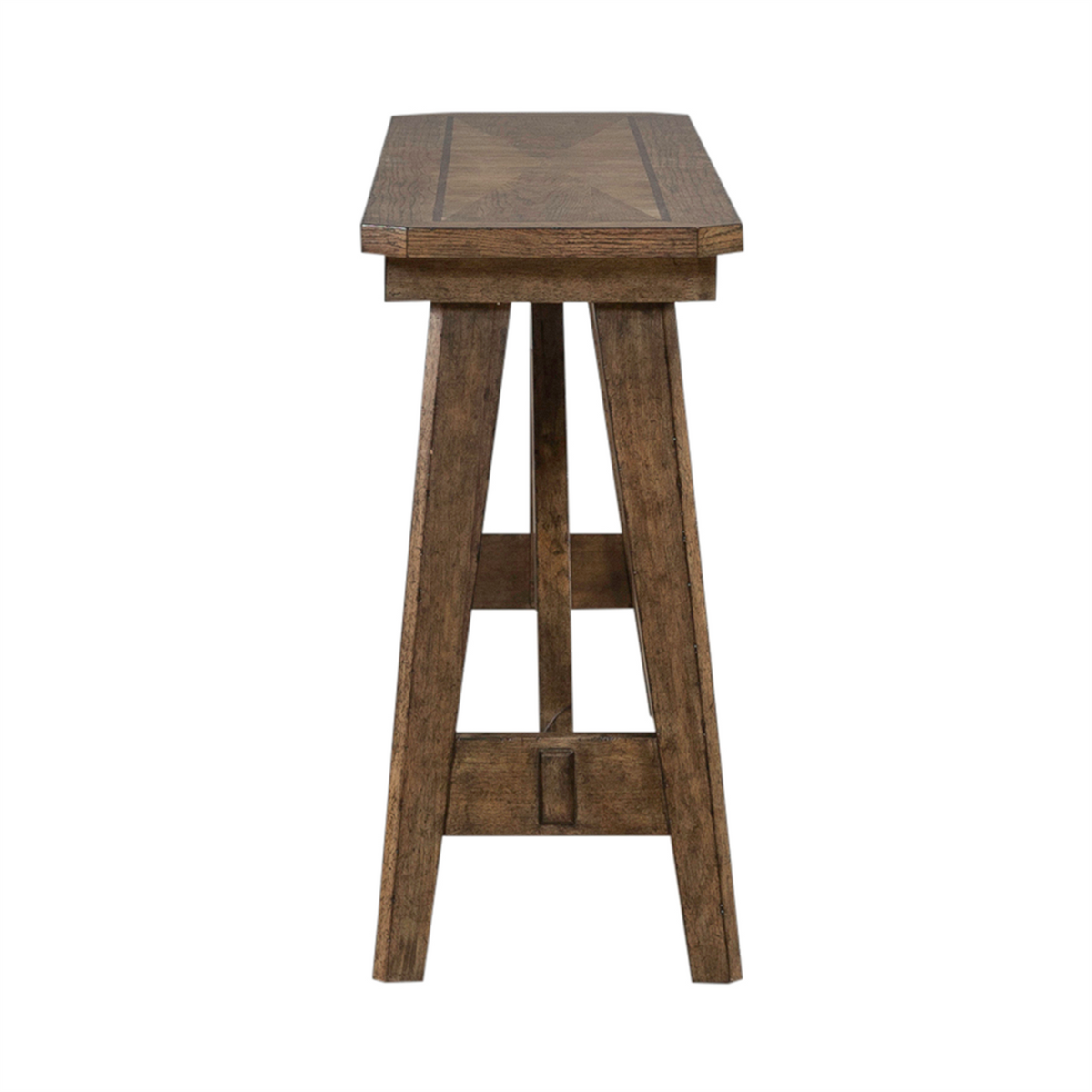 The Liberty Furniture Carolina Park Sofa Table 930-OT1030 is a narrow wooden table with a rectangular top and four angled legs, crafted with white oak veneers in an elegant Amber Brown finish, shown from the side against a white background.