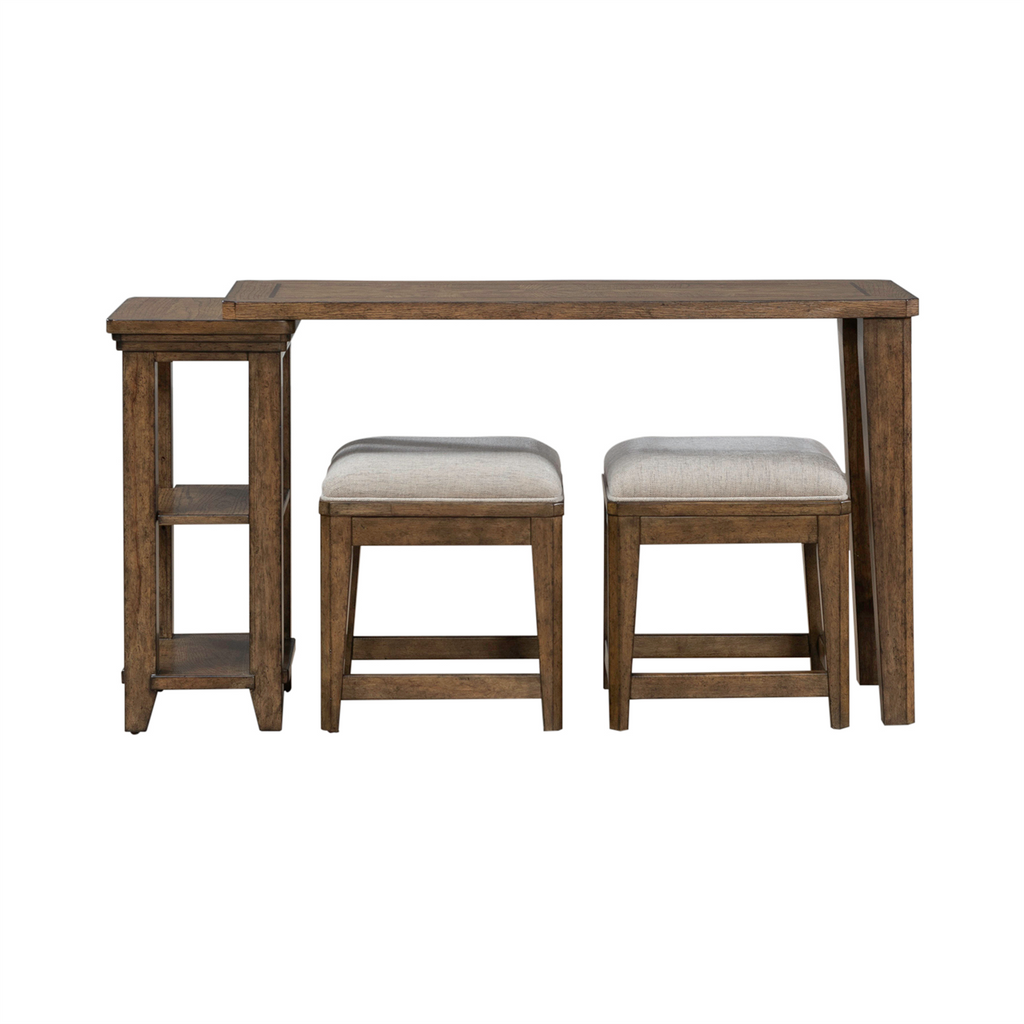 Showcased against a white background, the Liberty Furniture Carolina Park Console Table and 2 Stools set (930-OT5630-OT9001) features a rustic brown finish, includes a wooden bar-height console table with a matching narrow side shelf offering bookshelf storage, and comes complete with two beige upholstered stools.