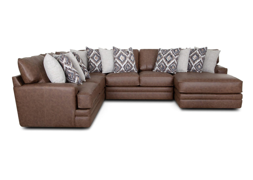The Asheville Duvall Vintage Brown Sectional 934-04-59-69-86-3429-16 by Franklin Furniture Corp. features a chaise lounge on the right side and is adorned with multiple decorative pillows in grey and patterned designs, all set against a plain white background; this sectional includes the WOW Seating System for exceptional comfort.