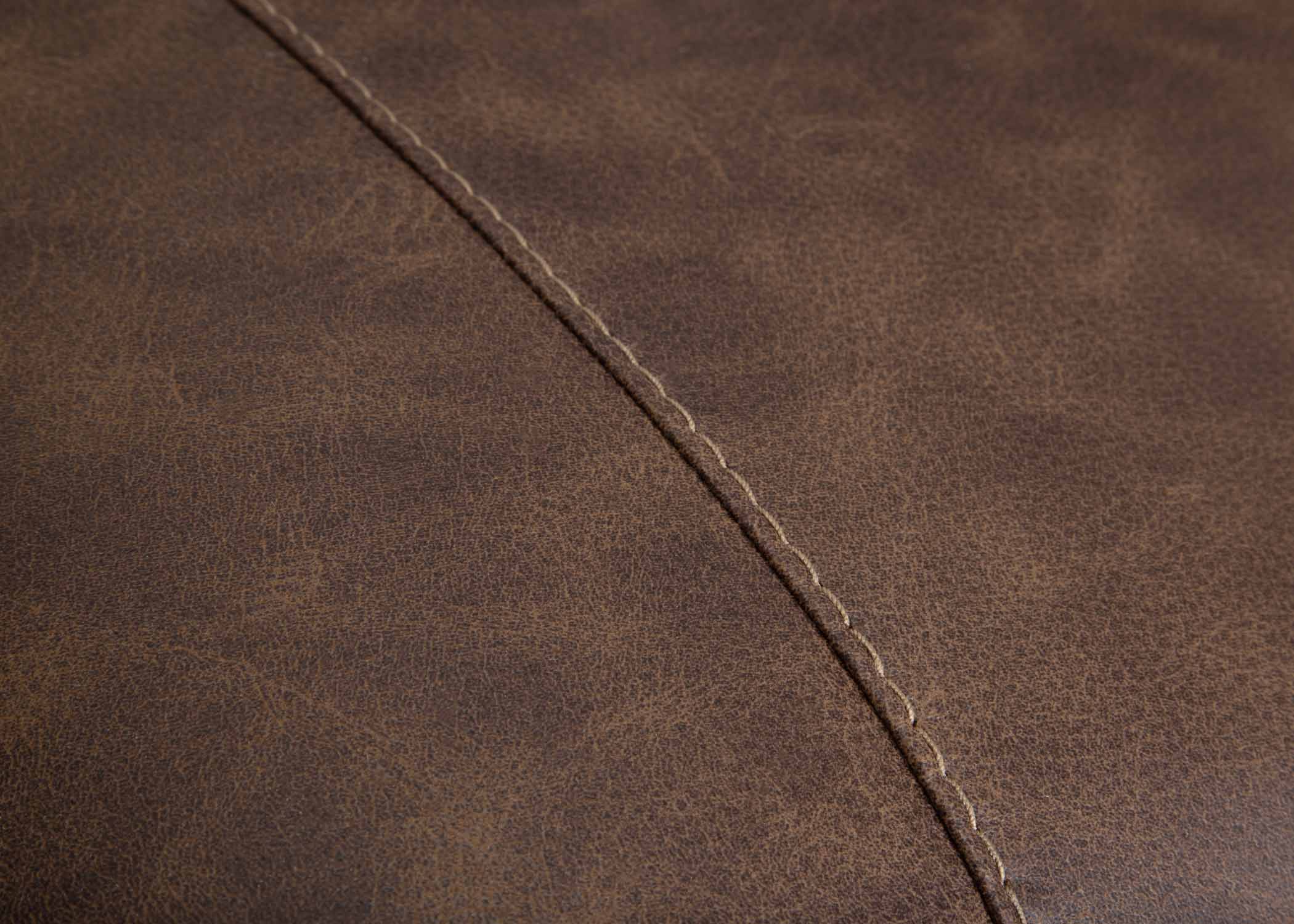 Close-up of brown leather upholstery with visible diagonal stitching highlights the texture and grain of the Franklin Furniture Corp. Asheville Duvall Vintage Brown Sectional (934-04-59-69-86-3429-16) material.