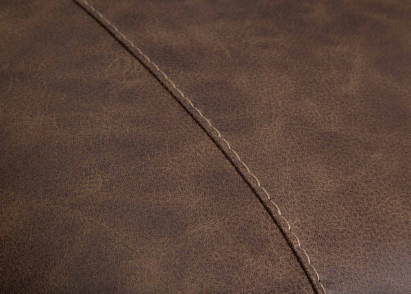Close-up of brown leather upholstery with visible diagonal stitching highlights the texture and grain of the Franklin Furniture Corp. Asheville Duvall Vintage Brown Sectional (934-04-59-69-86-3429-16) material.