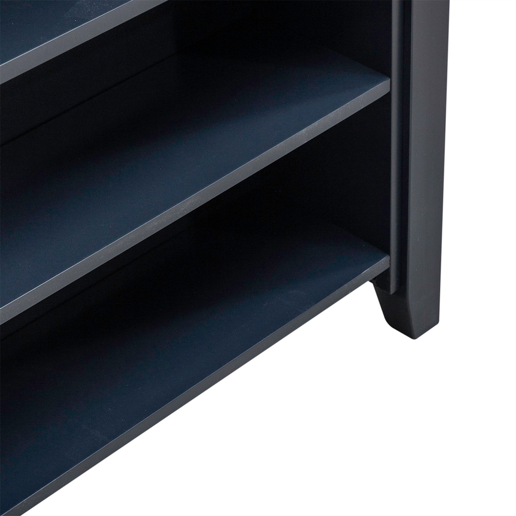 Close-up of the lower section of a dark-colored wooden shelf unit with two visible shelves and a sturdy leg on the right side, ideal for enhancing a small dining area or coordinating with the Liberty Furniture Brook Creek Table and 2 Chairs 942NY-CD-3CTS in navy blue.