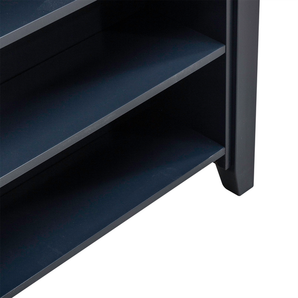 Close-up of the lower section of a dark-colored wooden shelf unit with two visible shelves and a sturdy leg on the right side, ideal for enhancing a small dining area or coordinating with the Liberty Furniture Brook Creek Table and 2 Chairs 942NY-CD-3CTS in navy blue.