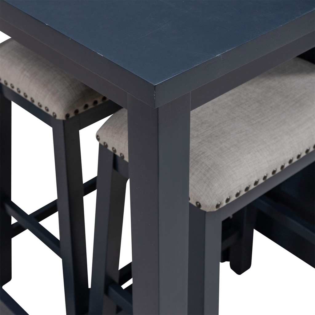Close-up of the Liberty Furniture Brook Creek Table and 2 Chairs set (942NY-CD-3CTS), showcasing a sleek black wooden tabletop paired with two matching chairs featuring light gray cushioned seats and nailhead trim, partially tucked beneath the table—an ideal setup for small space dining.