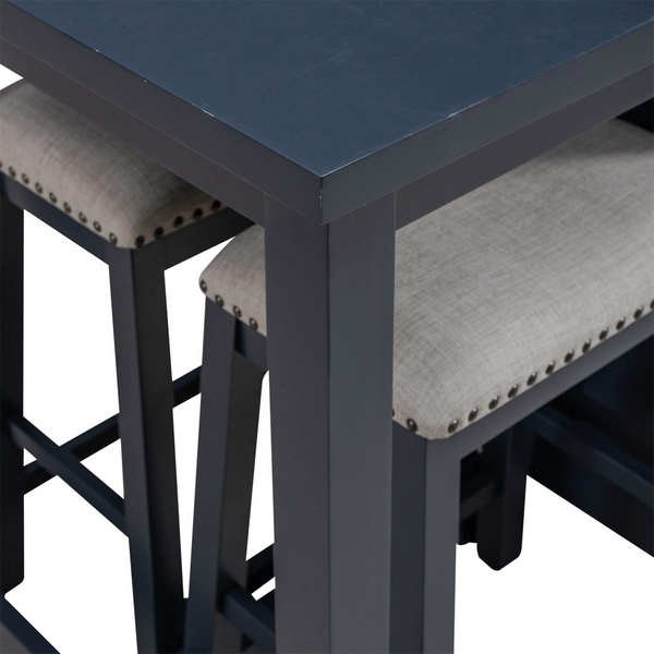 Close-up of the Liberty Furniture Brook Creek Table and 2 Chairs set (942NY-CD-3CTS), showcasing a sleek black wooden tabletop paired with two matching chairs featuring light gray cushioned seats and nailhead trim, partially tucked beneath the table—an ideal setup for small space dining.