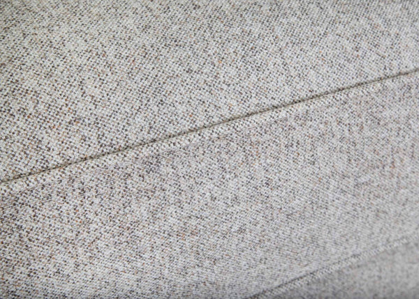 Close-up of light gray textured fabric upholstery with a visible seam running horizontally through the middle of the image, highlighting the exceptional craftsmanship of the Annisa Julien Cork Sofa 95740-3574-20 by Franklin Furniture Corp., featuring its WOW Seating System and reversible seat cushions.