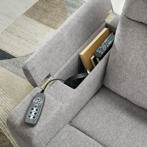 Ashley Pineland Pewter Power Recliner 9930642A in gray upholstery, featuring an armrest storage compartment with a remote and book, and a corded power recliner control unit.