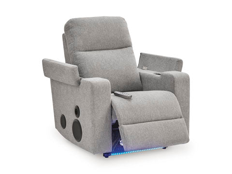 Ashley Pineland Pewter Power Recliner 9930642A in gray fabric, featuring side speakers, a remote control on the seat, and a blue LED light strip along the base.