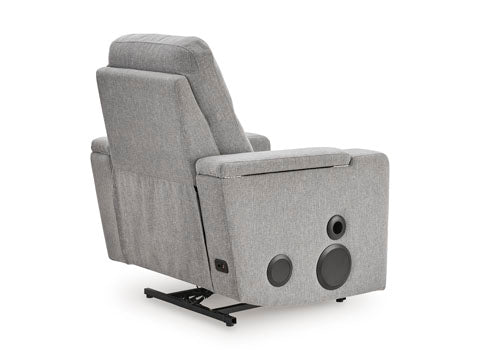 Back view of the Ashley Pineland Pewter Power Recliner 9930642A, a gray fabric home theater recliner with an integrated audio system featuring two circular speakers mounted on the side panel.