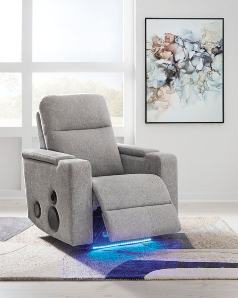 Light gray Ashley Pineland Pewter Power Recliner 9930642A featuring an integrated audio system with built-in side speakers and a blue LED light strip along the base.