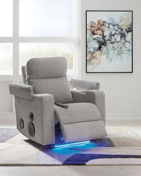 Pineland Pewter Power Recliner 9930642A in gray fabric, featuring an integrated audio system with built-in side speakers, a handheld remote, and a blue LED light strip along the base.