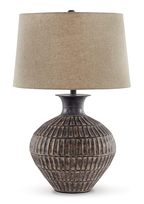 The Ashley Magan Lamp L207354 features a textured, round ceramic base with a bronze-tone finish and is topped with a wide beige fabric lampshade.