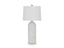 The Vauville White Lamp L243674 by Ashley features a white ceramic, textured ribbed base paired with a round white lampshade, creating a sculptural lamp silhouette that adds contemporary elegance to any space. Photographed against a plain white background, this table lamp from Ashley seamlessly blends style and functionality.