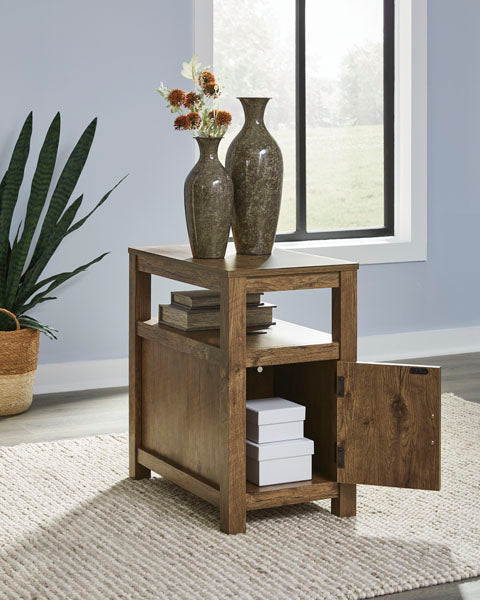 A rustic brown Fendenmore Brown Chairside End Table T190-117 featuring an open middle shelf and a lower cabinet door opened to reveal two stacked boxes, topped with two vases.