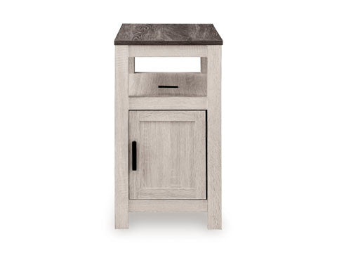 The Fendenmore White Chairside End Table T190-217 is a narrow end table featuring a dark wood top, an open storage shelf, and a single cabinet door with a black handle.