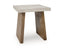 The Brendalhouse End Table T642-2 by Ashley features a small, modern design with a thick, light-colored faux cement tabletop and two angled wooden legs in a natural finish, making it perfect for adding contemporary style to any space.