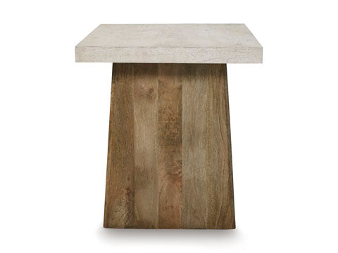 The Ashley Brendalhouse End Table T642-2 features a thick, light-colored faux cement tabletop and a trapezoidal base crafted from darker wood, creating a contemporary style accent for your space. Shown against a white background.