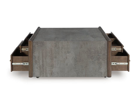 The Ashley Kallenny Cocktail Table T669-8 features a rectangular design with a gray, stone-like finish and multiple partially open side drawers on both sides, offering convenient storage while adding an industrial edge to your living space.